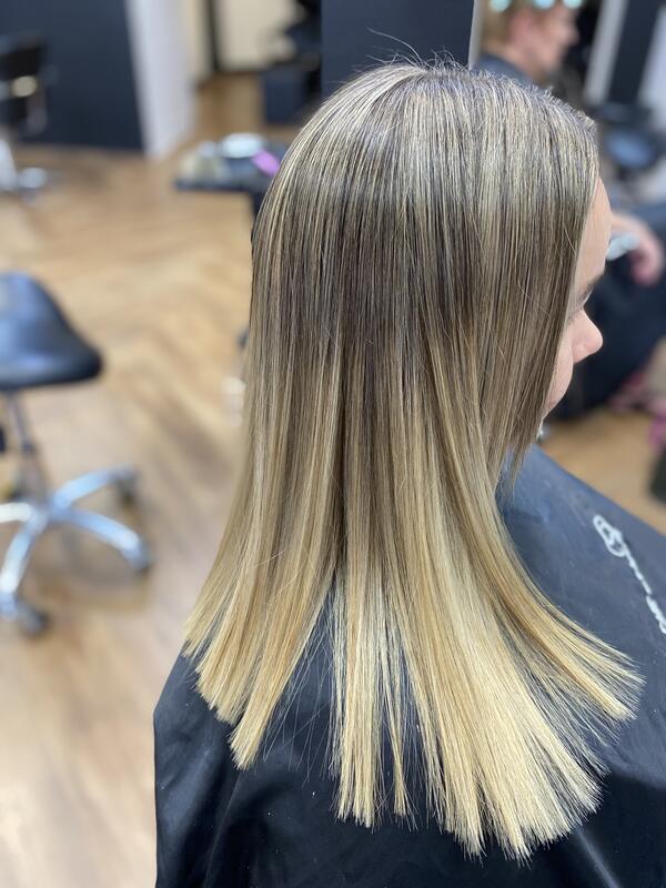 Sleek blonde foils and balayage on long straight hair